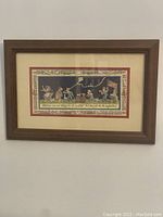 Full view of framed print mounted on wall showing children playing and decorative borders.