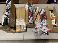 Boxes containing multiple packaged umbrellas with MLB tags visible