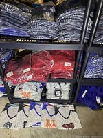 Shelves stacked with plastic-wrapped red Arizona Diamondbacks jersey tops in plus size, new with tags