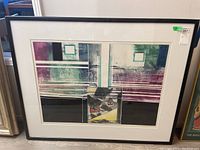 Full frontal photo of the abstract multi-colored framed art piece showing geometric shapes and lines in a black frame.