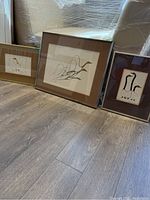 Three framed Benjamin Chee Chee prints on floor, including 'Friends', 'Dancing Goose' and one larger print.