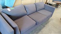 Front and top view of a dark gray Max Home three-seat fabric upholstered couch showing cushions and armrests.