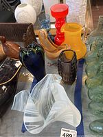 View of all art glass vases and jugs together showing variety of shapes and colors