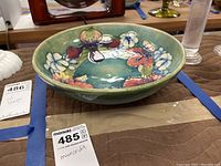 Top-down view showing full interior floral design and green background glaze.