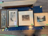 Full set of four framed prints laid out showing different art styles and frame types