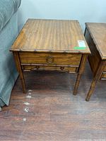 Full view of rectangular wooden side table showing wood grain finish and faux bamboo style legs and trim.