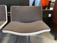 Front view of the upholstered bench seat and backrest showing the fabric pattern and white border trim.
