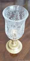 Photo of brass and crystal candle stand with etched pattern on glass and polished brass base