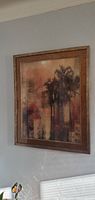 Side view of the framed picture showing the palm tree artwork on the wall.