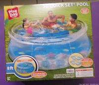 Box of the Play Day 8ft Quick Set Inflatable Pool showing image of pool with people inside.