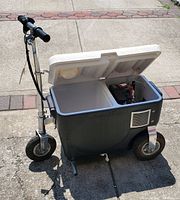 Front-side view with lid open showing overall structure and battery compartment