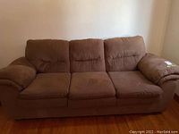 Front view of the brown microfiber suede-like couch showing seat and back cushions.