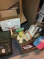 Second metal tool box with open socket set and other small tools, some loose hardware visible