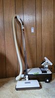 Full view of Panasonic Jet Flo canister vacuum cleaner with hose, telescopic wand, power head attached and vacuum canister body visible.