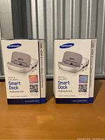 Two Samsung Galaxy Smart Dock multimedia hub boxes side by side highlighting front packaging with product image and branding