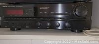 Front view of Denon DRA-425R receiver showing control panel and knobs