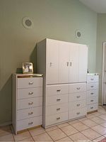 Front and right side view of the wall unit, showing the centerpiece and right end piece with a tile floor background and light colored wall.