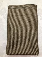 Full folded view of the camel and grey wool fabric showing the overall color and weave pattern