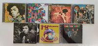 Front view of 7 Jimi Hendrix CD cases showing album cover art and designs