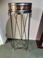 Full view of the metal stand with tripod legs and copper/brass banded removable top