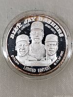 Front side of the coin showing embossed faces of Joe Carter, Roberto Alomar, Devon White, with text 'Blue Jay Bashers' and 'Limited Edition 316'