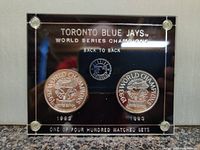 Front view of acrylic plaque displaying both coins with 'Toronto Blue Jays World Series Champions Back to Back' inscription and coins for 1992 and 1993