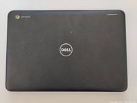 Top view of the closed Dell Inspiron 3181 Chromebook showing Dell and Chrome logos with matte black finish.