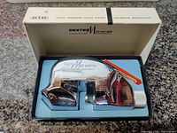 Top view of the Dexter Mat Cutter tool with spare blades in original fitted foam insert inside the box.