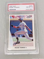 Front view showing Frank Thomas batting in Chicago White Sox uniform with PSA grading label NM-MT 8