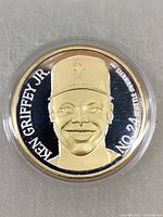 Front of coin showing gold portrait of Ken Griffey Jr. with inscription and number 24.
