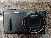 Front view of black Panasonic Lumix DMC-ZS45 camera showing lens and textured grip