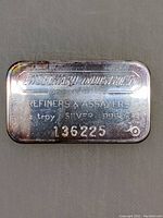 Photo of a silver bar stamped with 'Engelhard Industries of Canada', 'Refiners & Assayers', '1 oz troy Silver .999 Fine', and serial number '136225'.