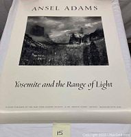 Full view of the Ansel Adams poster rolled out partially, showing the image and text clearly with visible measurements noted.