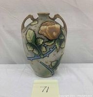 Front view of hand painted Nippon vase with floral and maple leaf motifs, showing raised Moriage decor and two handles.