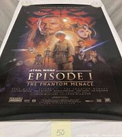 Star Wars Episode I The Phantom Menace movie poster displayed flat showing central characters and title