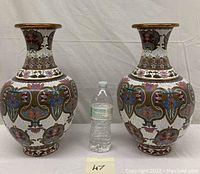 Front view of both vases with water bottle for scale