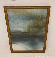 Full view of the framed painting showing abstract landscape in muted blues and greens.