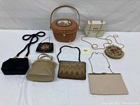 Wide view of all 8 vintage women's evening bags showing different styles, shapes, and materials.