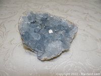 Close up of the blue-teal celestite crystal cluster inside the geode showing crystal formation and color.