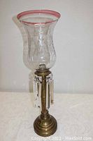 Full view of antique Russian brass candleholder with etched crystal hurricane glass shade and hanging crystal prisms
