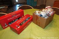 Two boxed sets of 10 fancy plastic candle Christmas tree lights each, showing original packaging boxes.