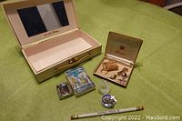 Wide shot of all items in the lot showing the vintage Elizabeth Arden jewelry box, playing cards, lighter, rosary, political pencil, and Pennino tie tack box with tie tacks.