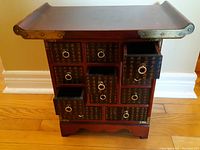 Front view of mini cabinet with drawers partially open
