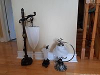 Full set of three assorted lamps against wall, showing range of sizes and styles