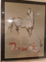 Full view of the framed horse painting behind glass showing the horse figure and red signature.