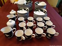 Full display of Sanyo Quadrille dinner set arranged on table showing mugs, creamer, and sugar bowl with lids