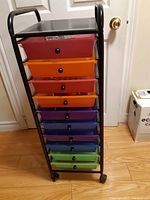Front view of the multi-color plastic drawer trolley with metal frame.