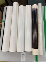Six rolled posters viewed from the top making it difficult to see images, showing condition and size.