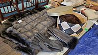 Photo of faux fur blanket, two pairs of black gloves (one Lord & Taylor), and vintage mink hat in hatbox