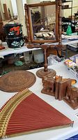 Mid-century wooden shoe form, Asian fan, wooden swivel mirror on stand, elephant bookends, and collegiate plaque shown together on table.
